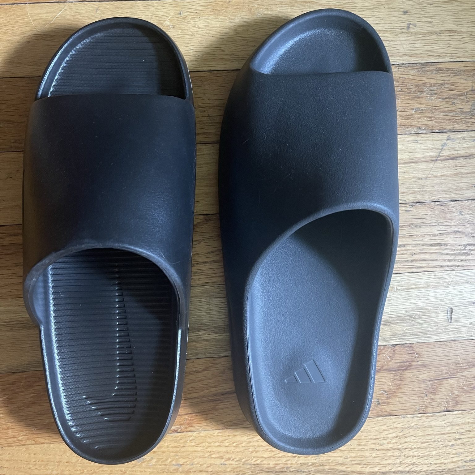 top view of nike calm slides and adidas yeezy slides