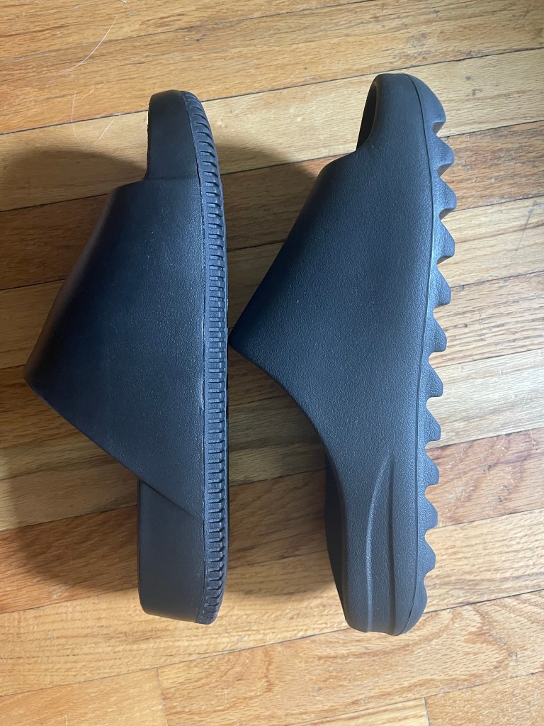 side profile of yeezy slides and nike calm slides